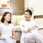 Asian couple chatting about relationship and marital problems at home